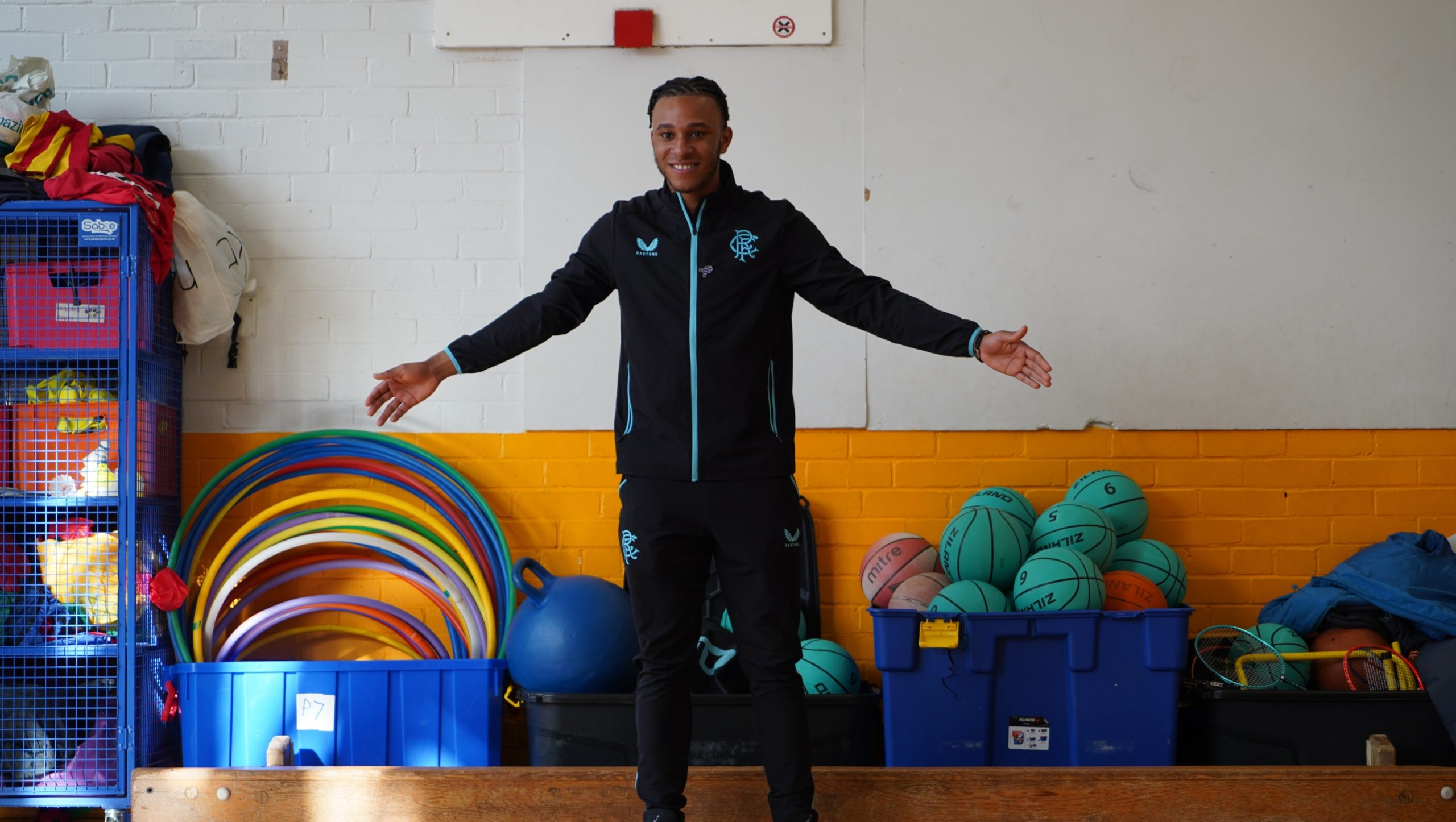 Zak Lovelace standing in a primary school gym hall