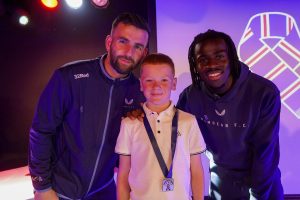 kid with medal and two players